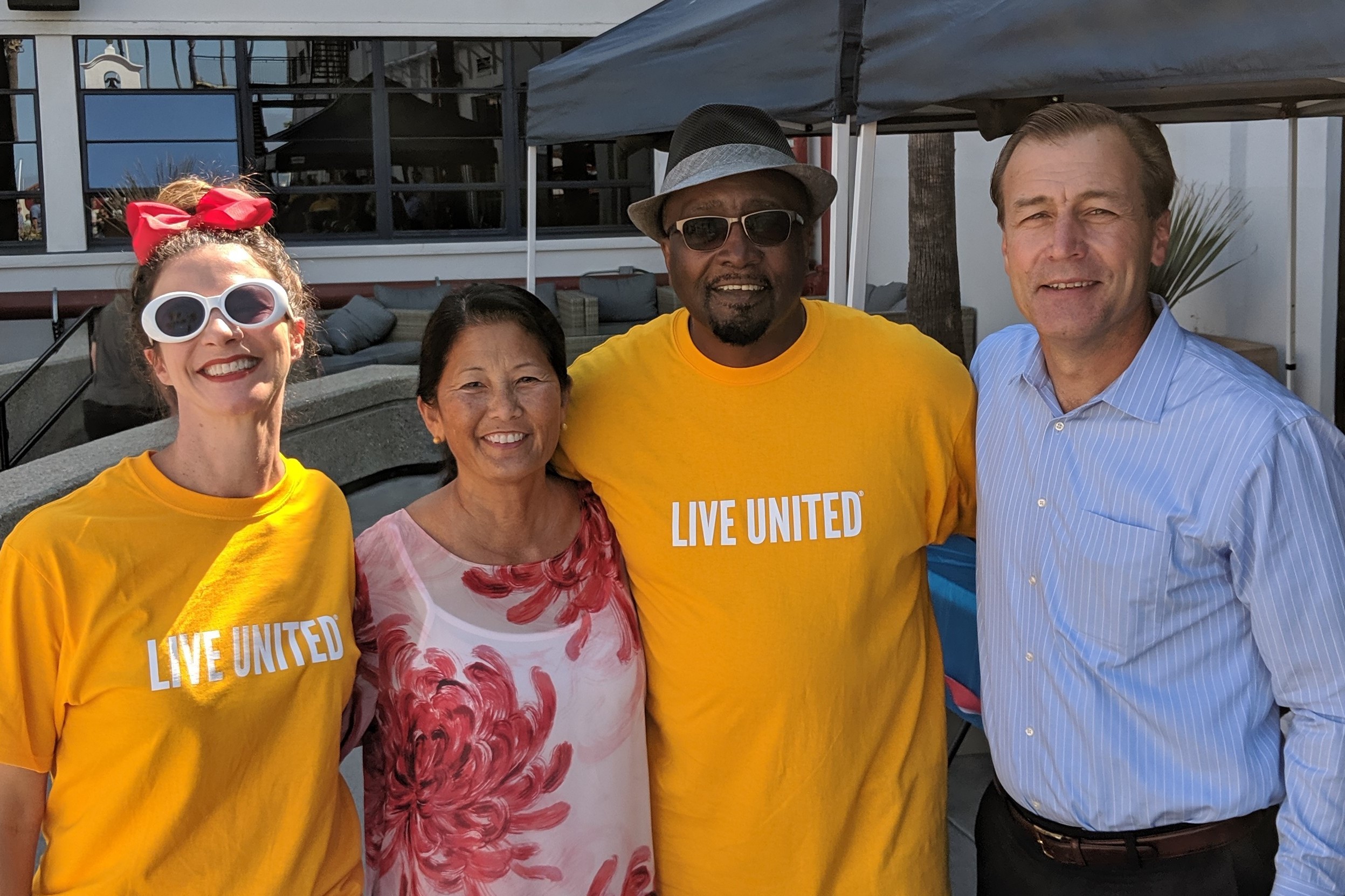 Nancy poses for a photo with people wearing yellow "Live United" shirts
