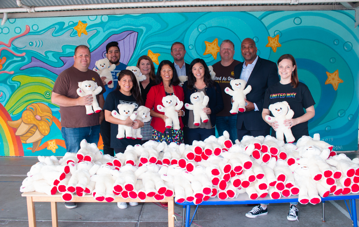 UWSD CEO Nancy Stands With a Group of Employees Holding Build-a-Bears