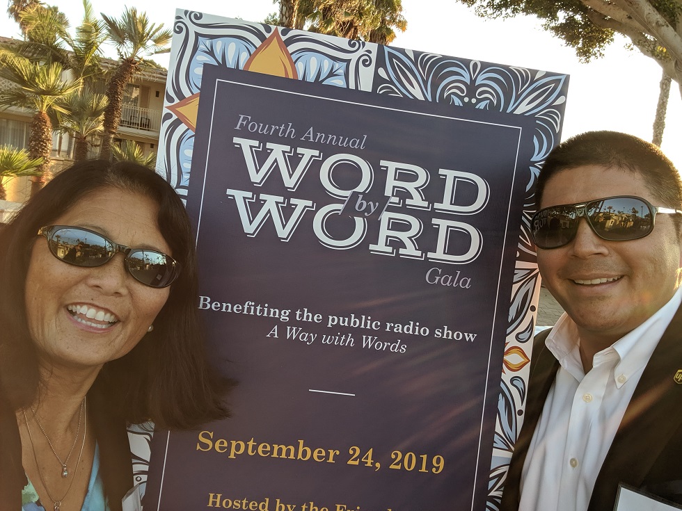 Nancy and man stand by sign that reads "word by word gala"