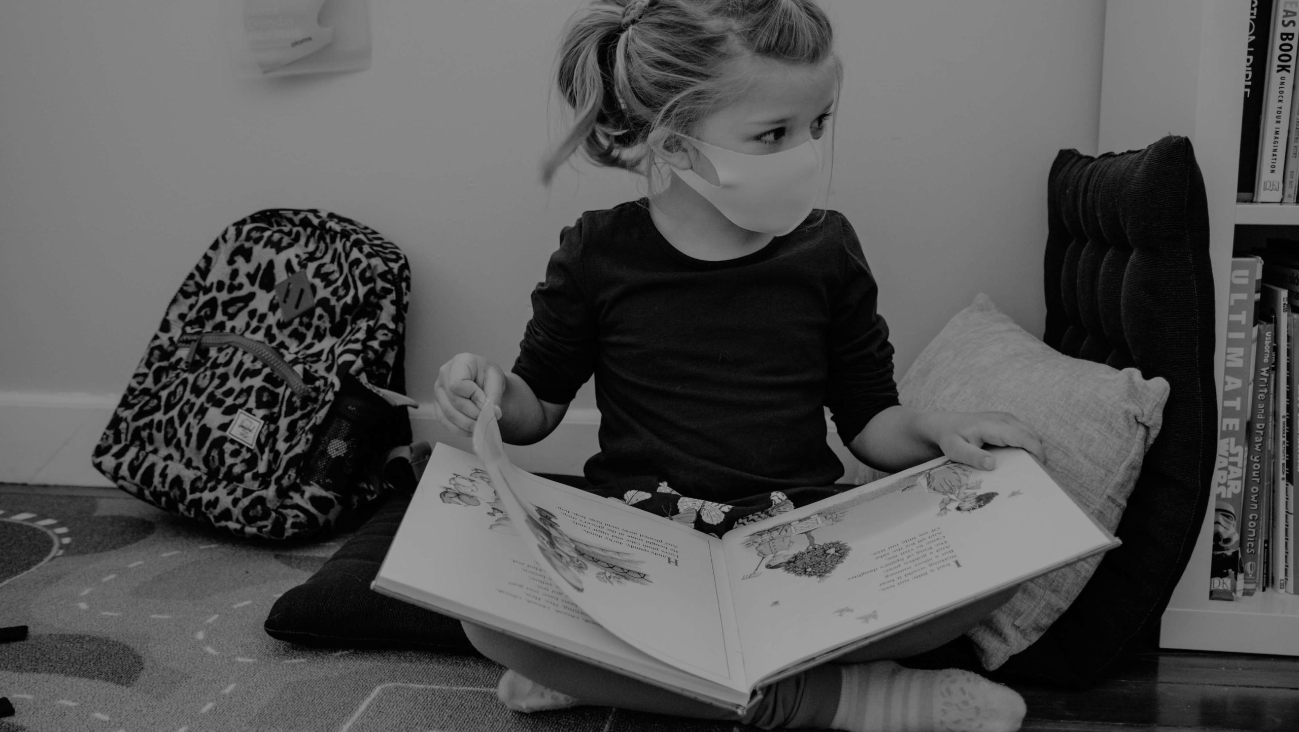 Young elementary student reading a book