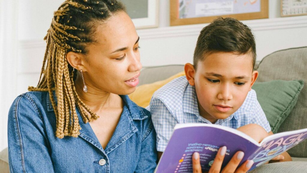 mother and son reading a book together at home