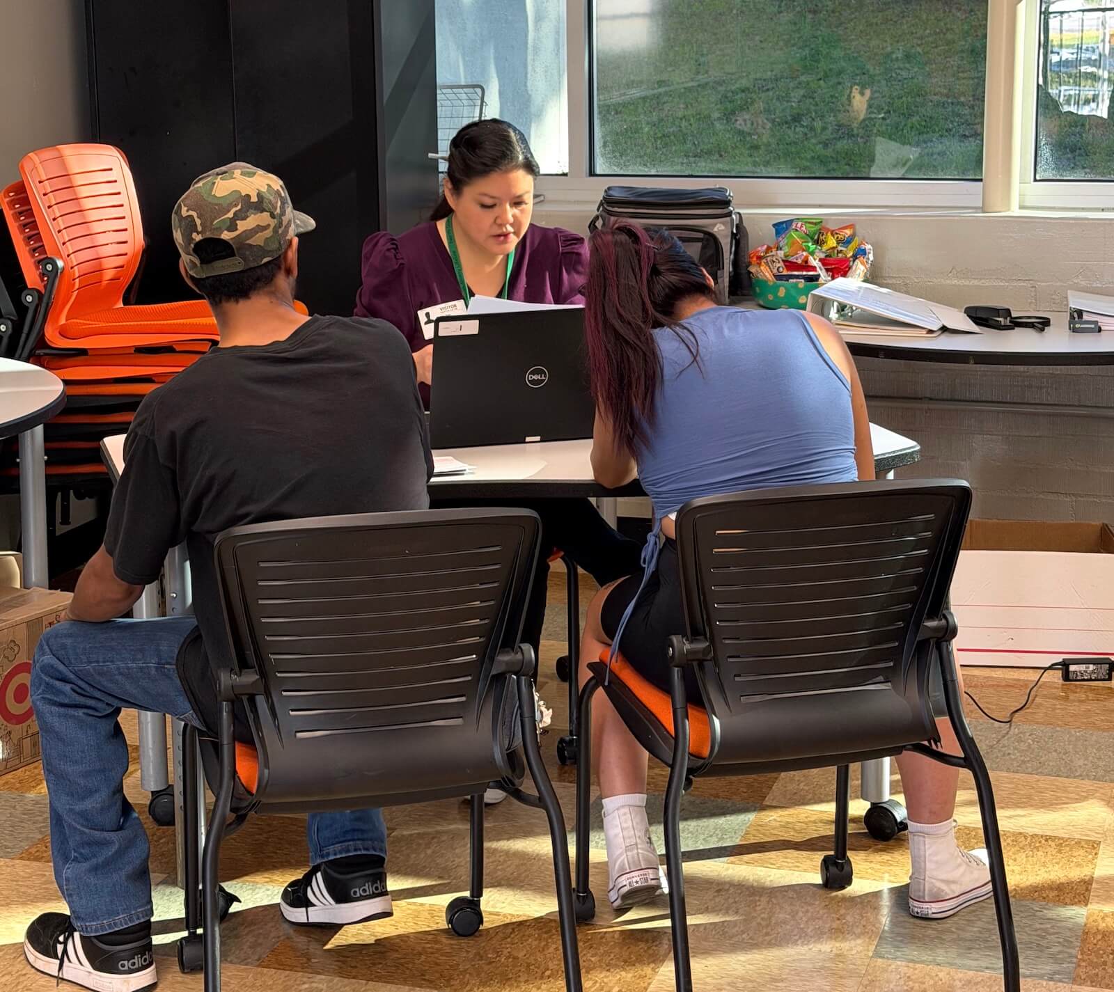 Two students at Escondido High School receive free tax prep assistance from a VITA volunteer as part of the San Diego EITC Coalition