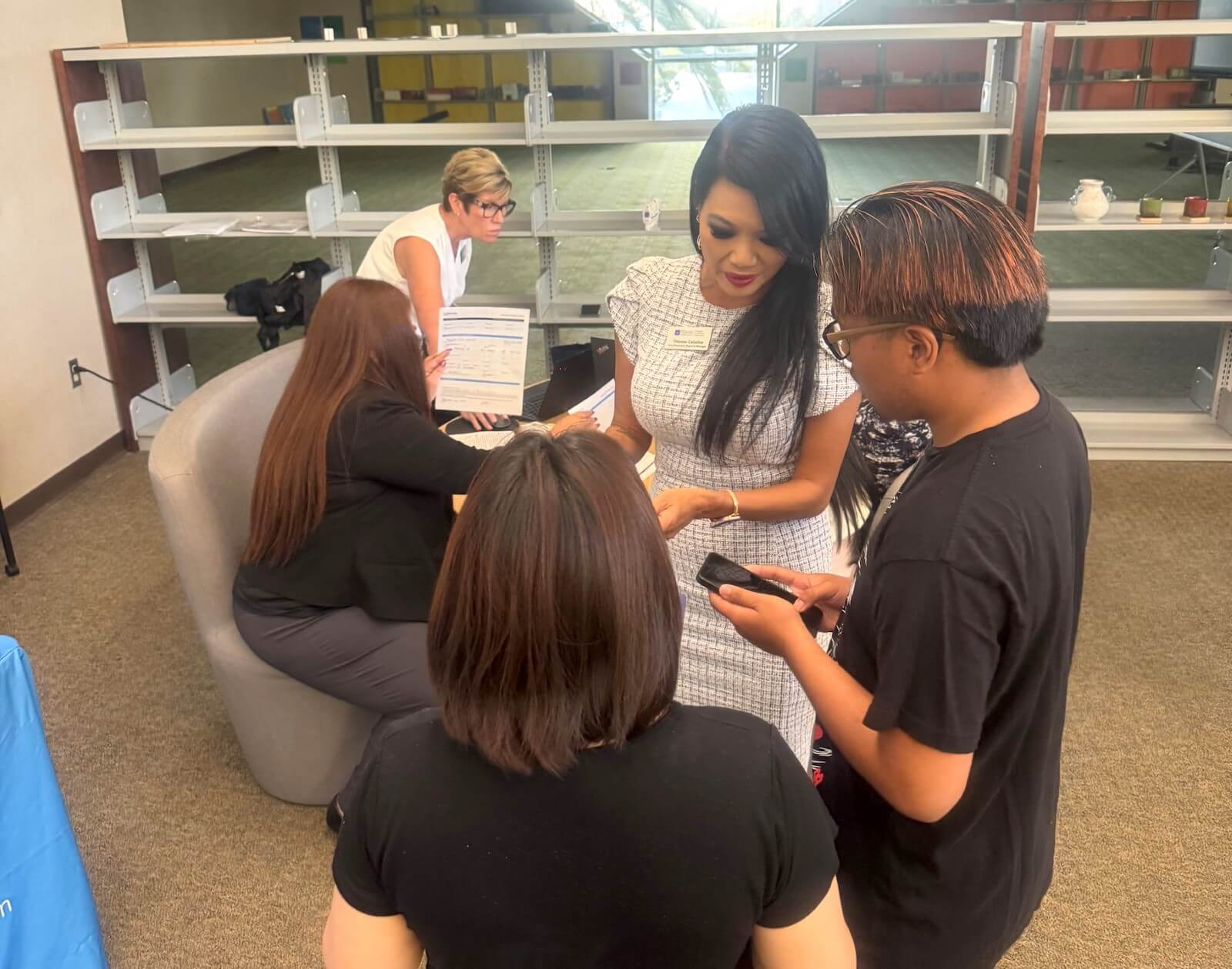 Team members from North Island Credit Union help students sign up for checking accounts.