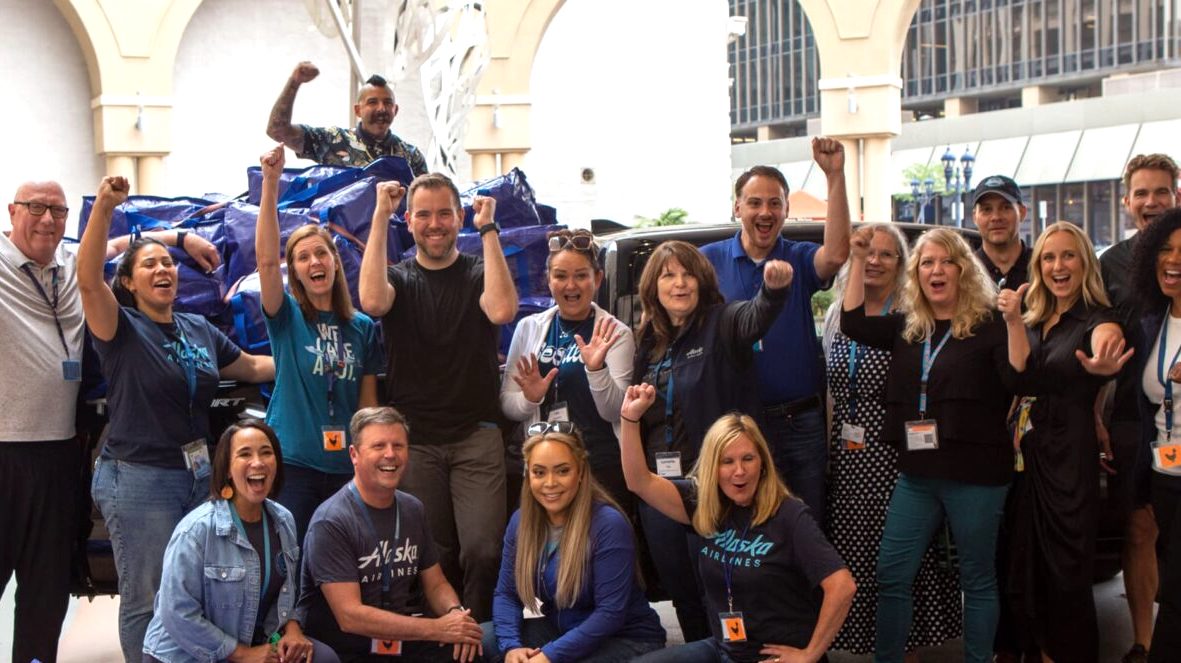 A group of Alaska Airlines employees posing for a photo during a corporate social responsibility volunteering opportunity with UWSD in San Diego