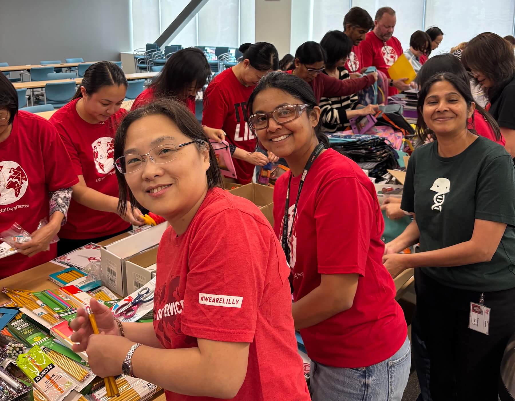Eli Lilly and Company employees stuffing school supplies into backpacks during a CSR volunteer event with United Way of San Diego County